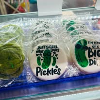 Round cookies iced with pickle drawings and pickle jokes